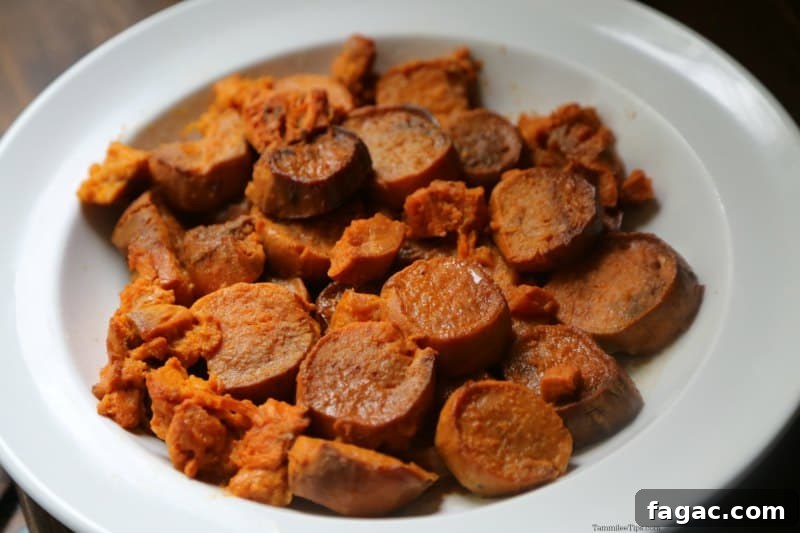 Slow Cooker Candied Sweet Potatoes on a white serving dish