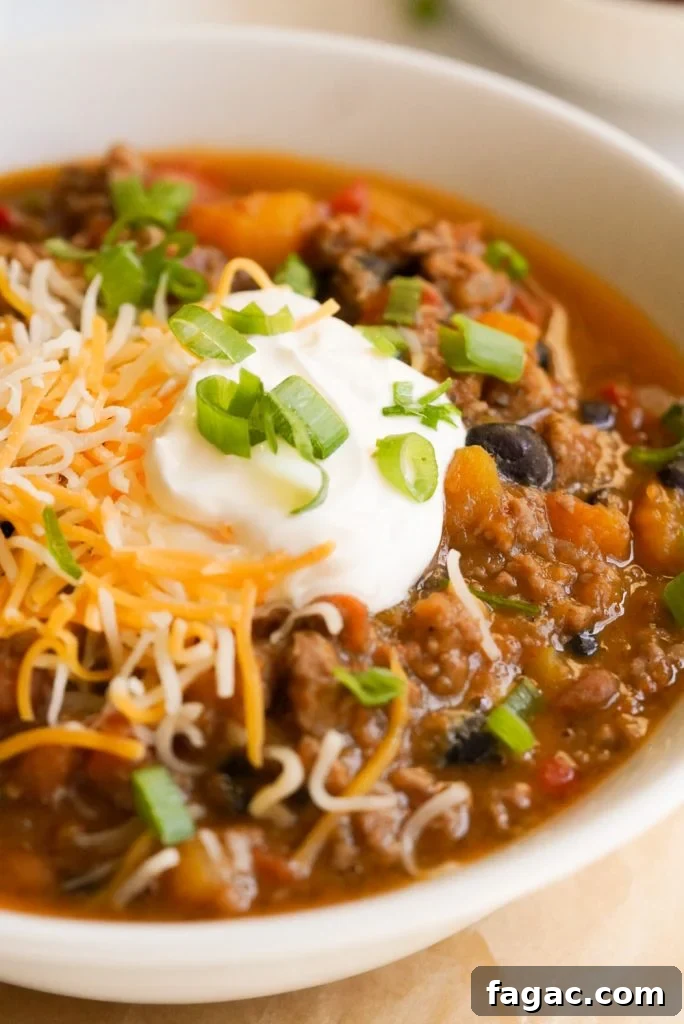 Hearty Butternut Squash and Turkey Chili Recipe 9 chili topped with sour cream, cheese, and green onions