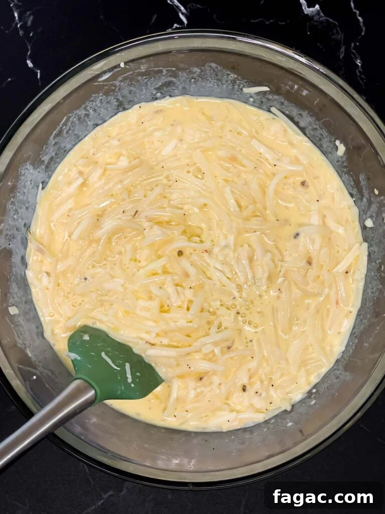 Sausage and Hashbrown Breakfast Casserole for 12 Guests 11 Egg, hash browns, and cheese mixture stirred together until evenly combined
