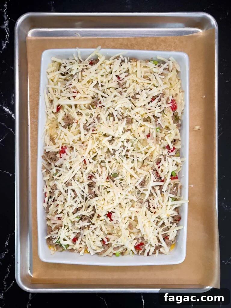 Sausage and Hashbrown Breakfast Casserole for 12 Guests 14 Unbaked sausage hashbrown breakfast casserole spread evenly in a 9x13 baking dish.