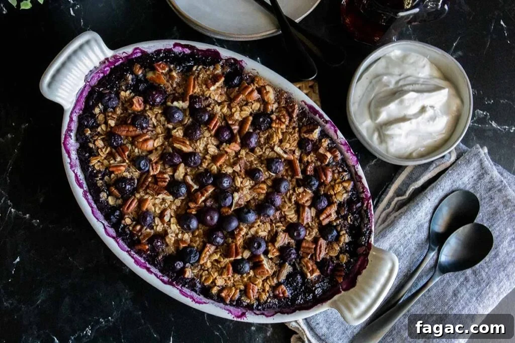 Sausage and Hashbrown Breakfast Casserole for 12 Guests 19 Blueberry baked oatmeal in a white oval baking dish.