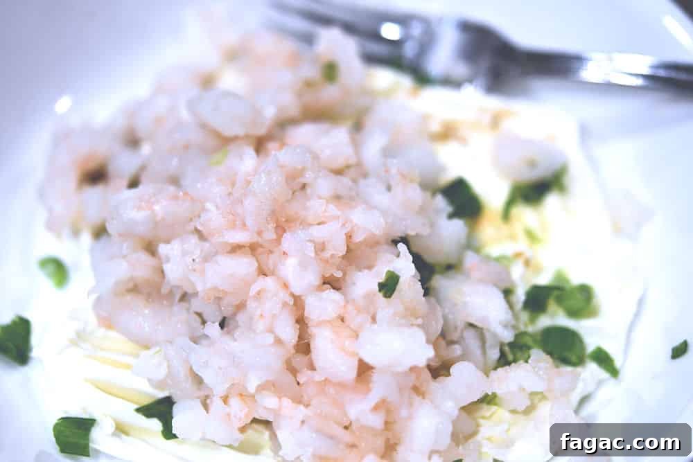 chopped shrimp in a bowl, ready to mix with cream cheese.
