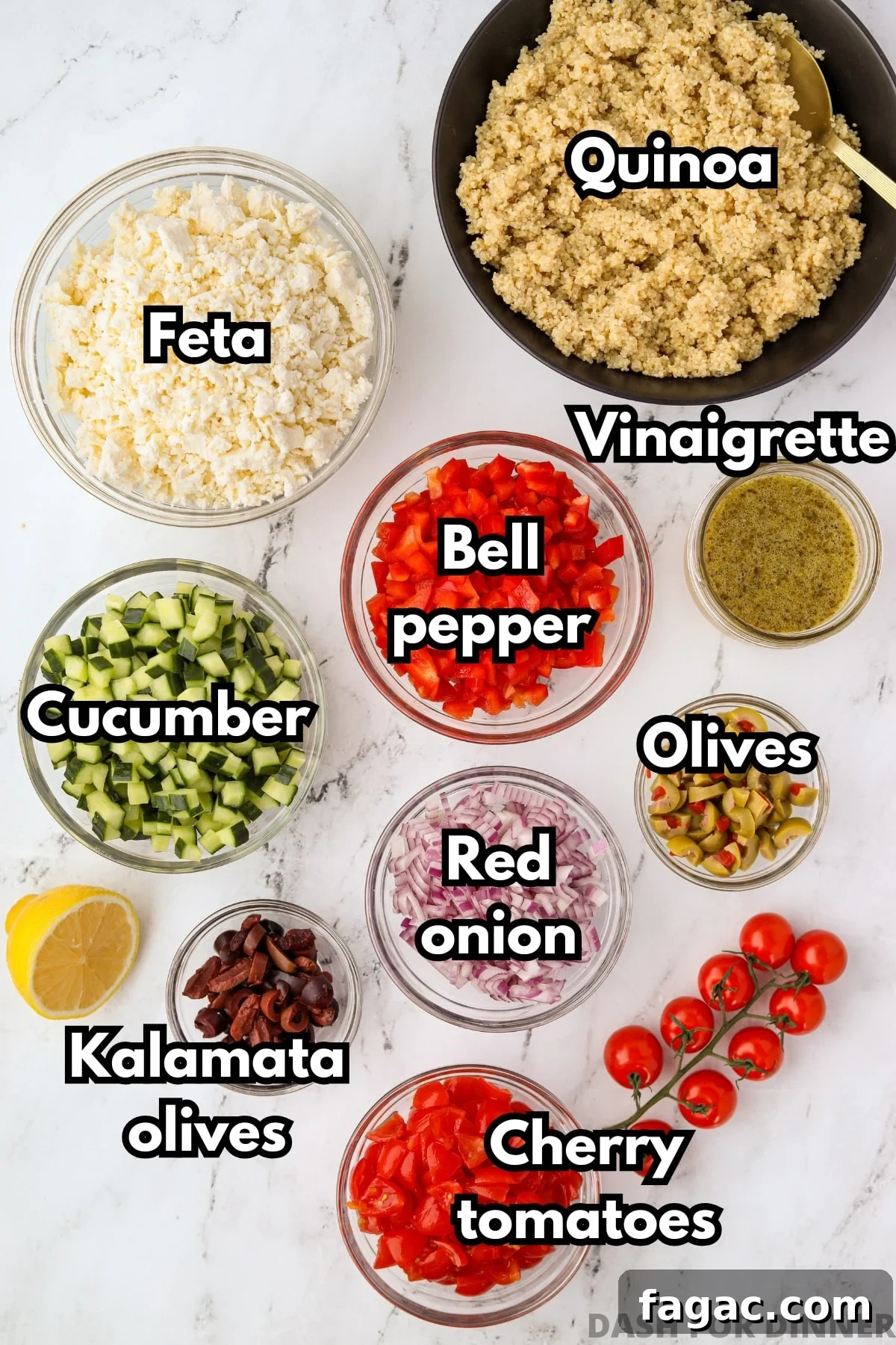 The ingredients needed to make a Greek style quinoa salad, including cucumbers, bell pepper, red onion, and olives.