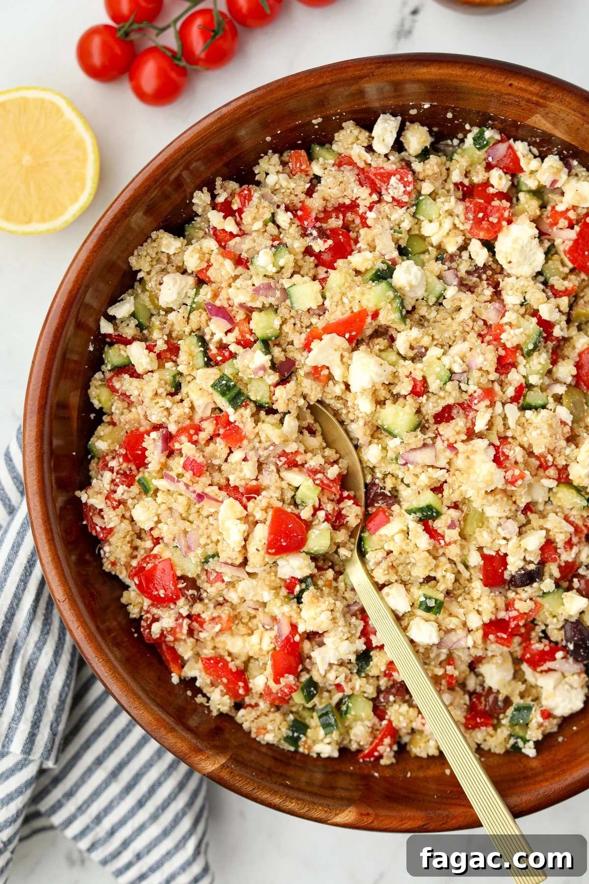 A large wooden bowl filled with quinoa salad.