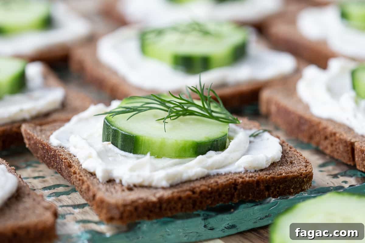 Mini Cucumber Sandwiches: Light Tea Sandwich Recipe 4 mini cucumber sandwiches on a glass platter.