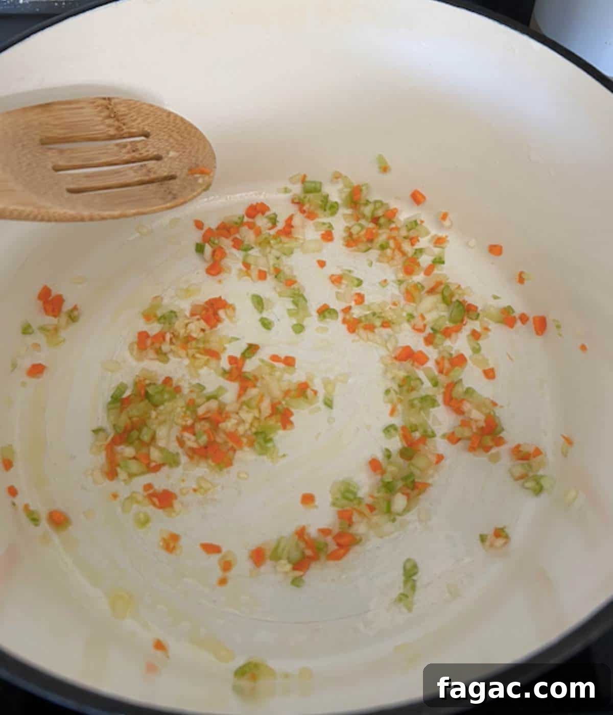 Vegetables softening in dutch oven.