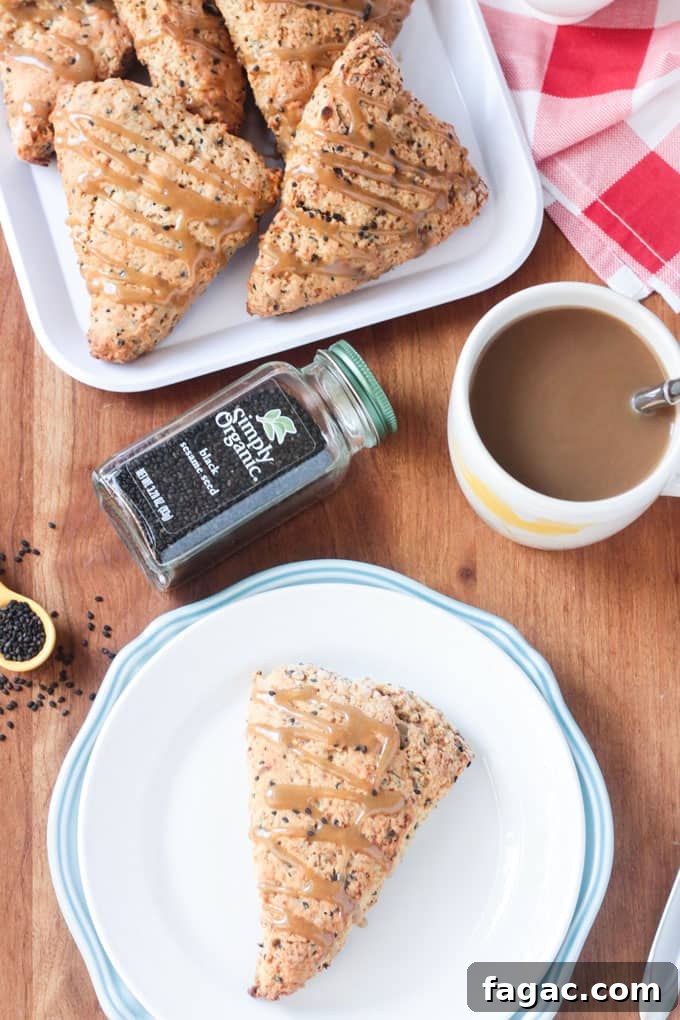 Banana Black Sesame Vegan Scones - easy dairy free scones with a surprisingly delightful flavor combo. Just sweet enough with no refined sugar. They have the perfect balance of sweet and nutty. You've gotta try these amazing scones - breakfast, brunch, tea time, even dessert! Plate of scones, cup of coffee, and a spice container of Simply Organic Black Sesame Seeds.