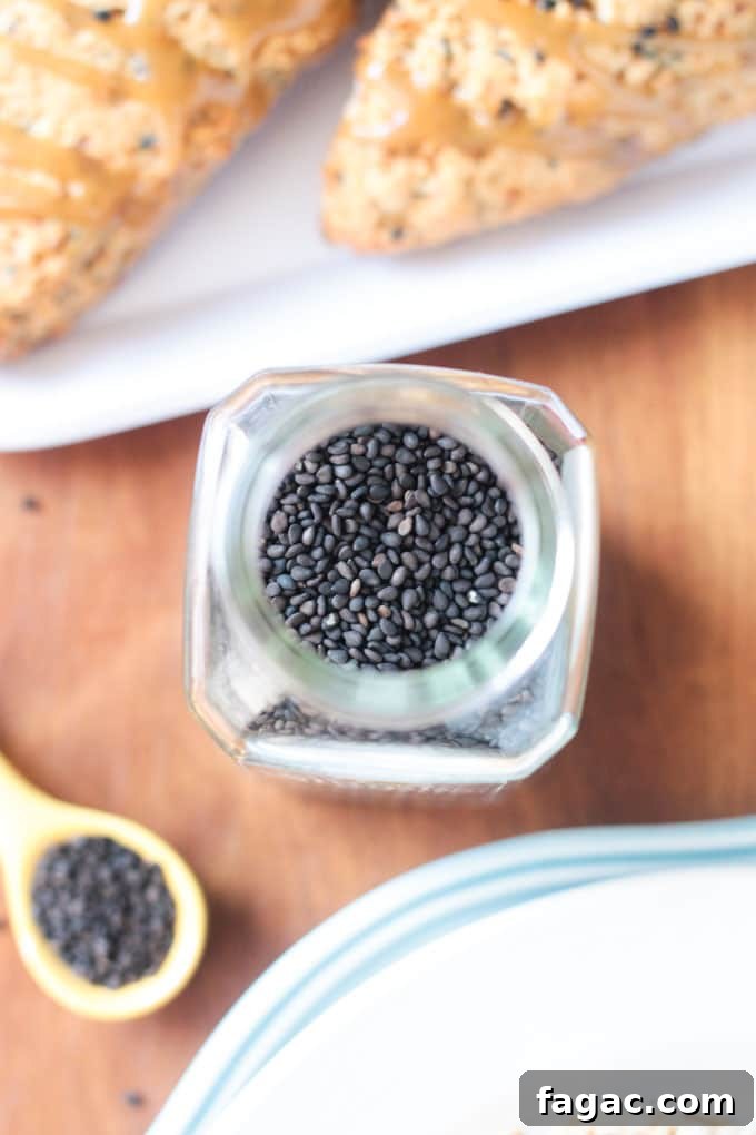 Banana Black Sesame Vegan Scones - easy dairy free scones with a surprisingly delightful flavor combo. Just sweet enough with no refined sugar. They have the perfect balance of sweet and nutty. You've gotta try these amazing scones - breakfast, brunch, tea time, even dessert! Overhead shot looking into a spice container of black sesame seeds.