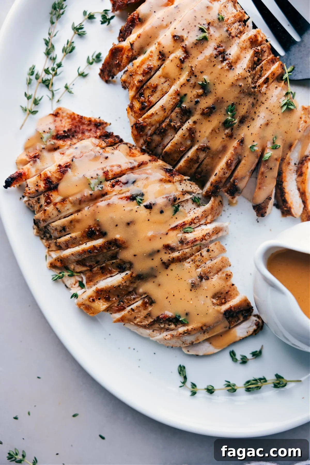 Ready-to-Serve Turkey Covered in Savory Gravy on a Plate Finished turkey covered in savory gravy, served on a plate, ready for enjoyment.
