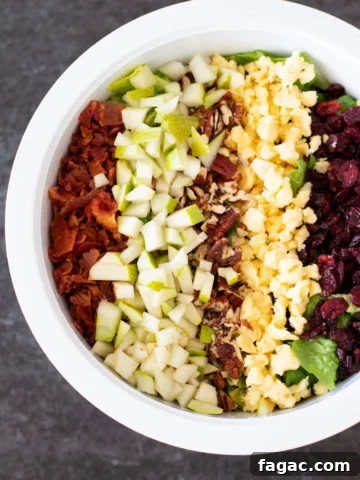 Autumn Chopped Salad in a white bowl on marble counter.