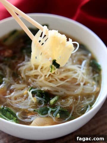 A white bowl of Asian Chicken Noodle Soup