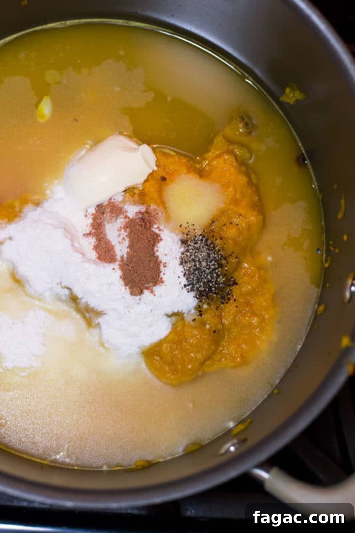 Creamy Hubbard Squash Soup Recipe for Fall Comfort 9 Squash puree, rice flour, butter, nutmeg and water in a pot on the stove top.