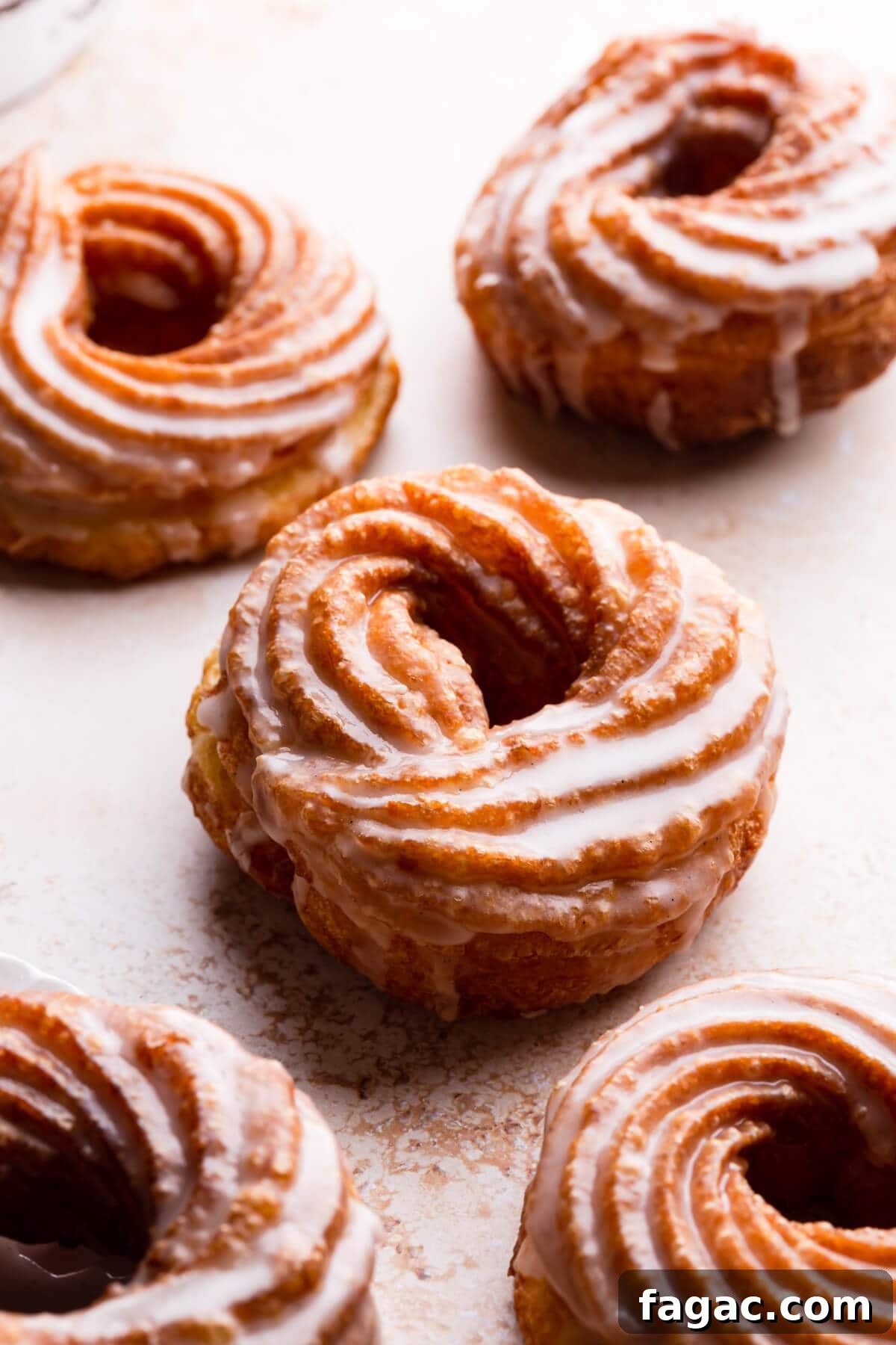Classic French Cruller Donuts: Light, Crispy Pastry Recipe 9 45 degree angle close up view at choux pastry doughnuts dipped in glaze