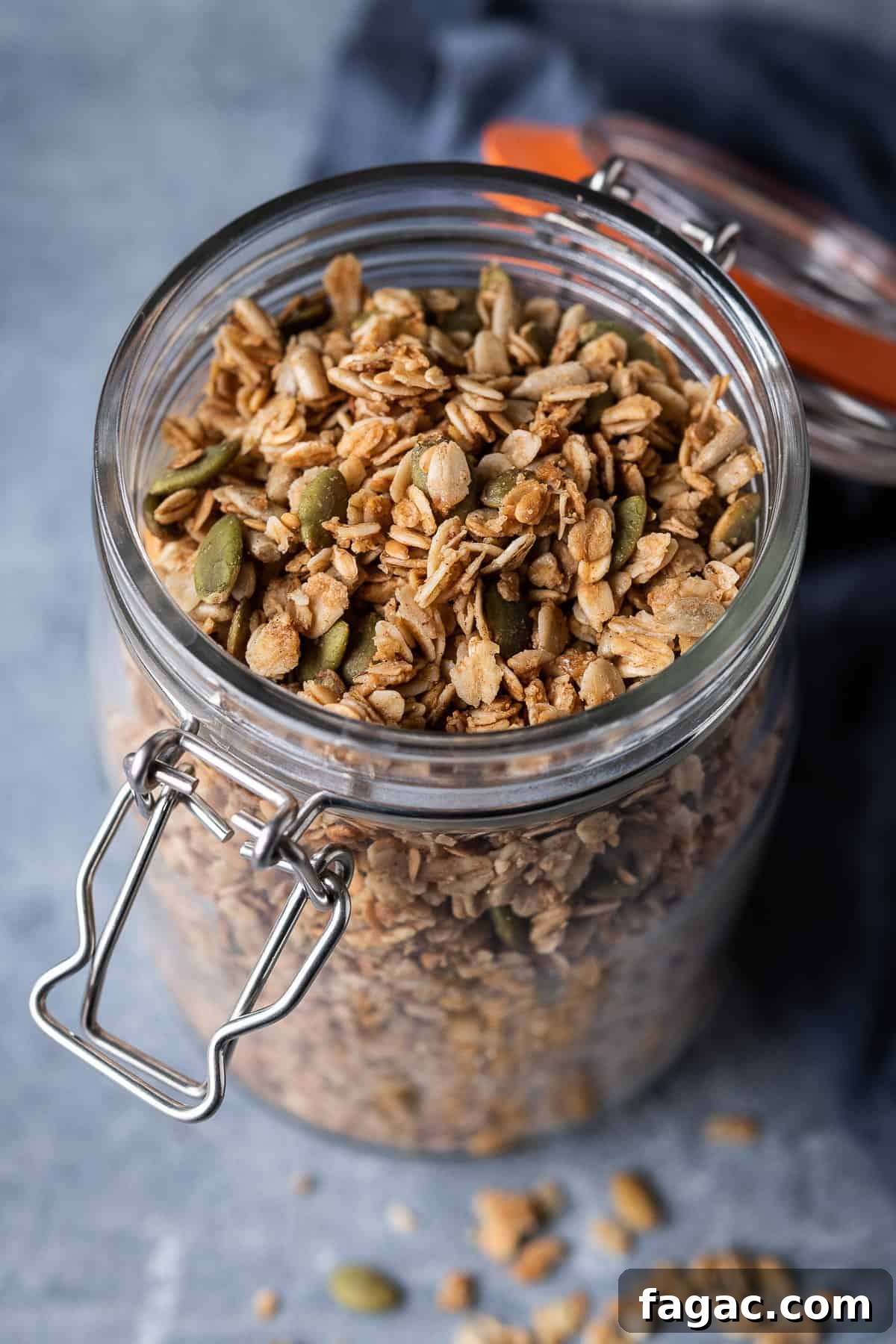 Jar of homemade vegan granola a glass jar full of vegan granola.