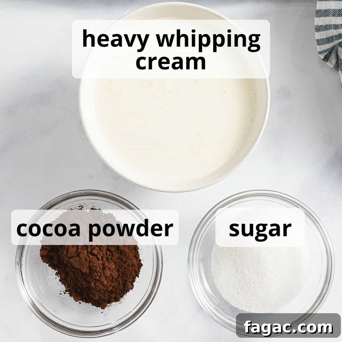Ingredients for chocolate whipped cream including heavy whipping cream and cocoa powder.