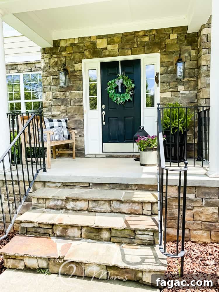 before photo of small front porch decorated for summer with bench and plants