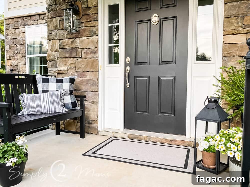 front porch with flowers in pots and bench