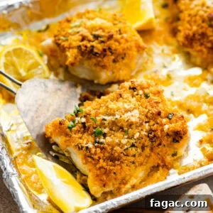 Crispy Panko-Baked Cod with Lemon Garlic Sauce 12 baked cod with panko after baking on the baking sheet. Lemons on the tray.