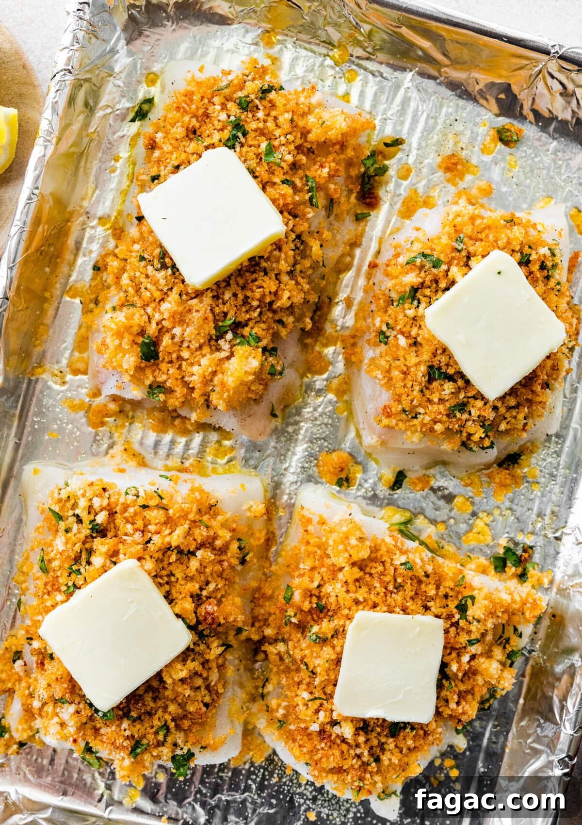 Crispy Panko-Baked Cod with Lemon Garlic Sauce 10 cod on a baking sheet with tin foil on it. Olive oil on the cod. Add butter on top.