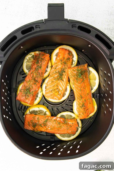Crispy Air Fryer Salmon with Fresh Dill Recipe 4 raw salmon filets in an air fryer basket