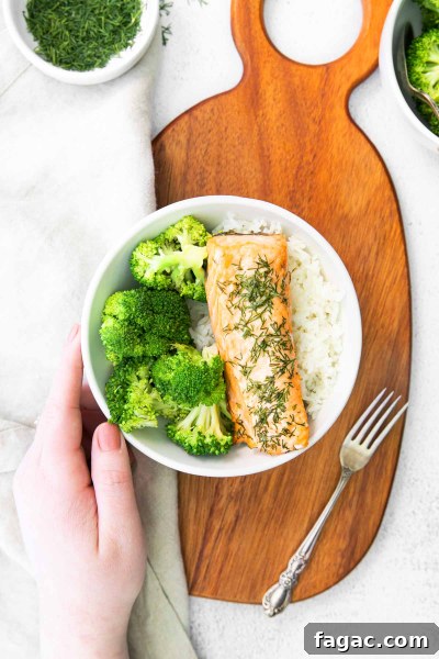 Crispy Air Fryer Salmon with Fresh Dill Recipe 5 hand on a plate with salmon ready to eat