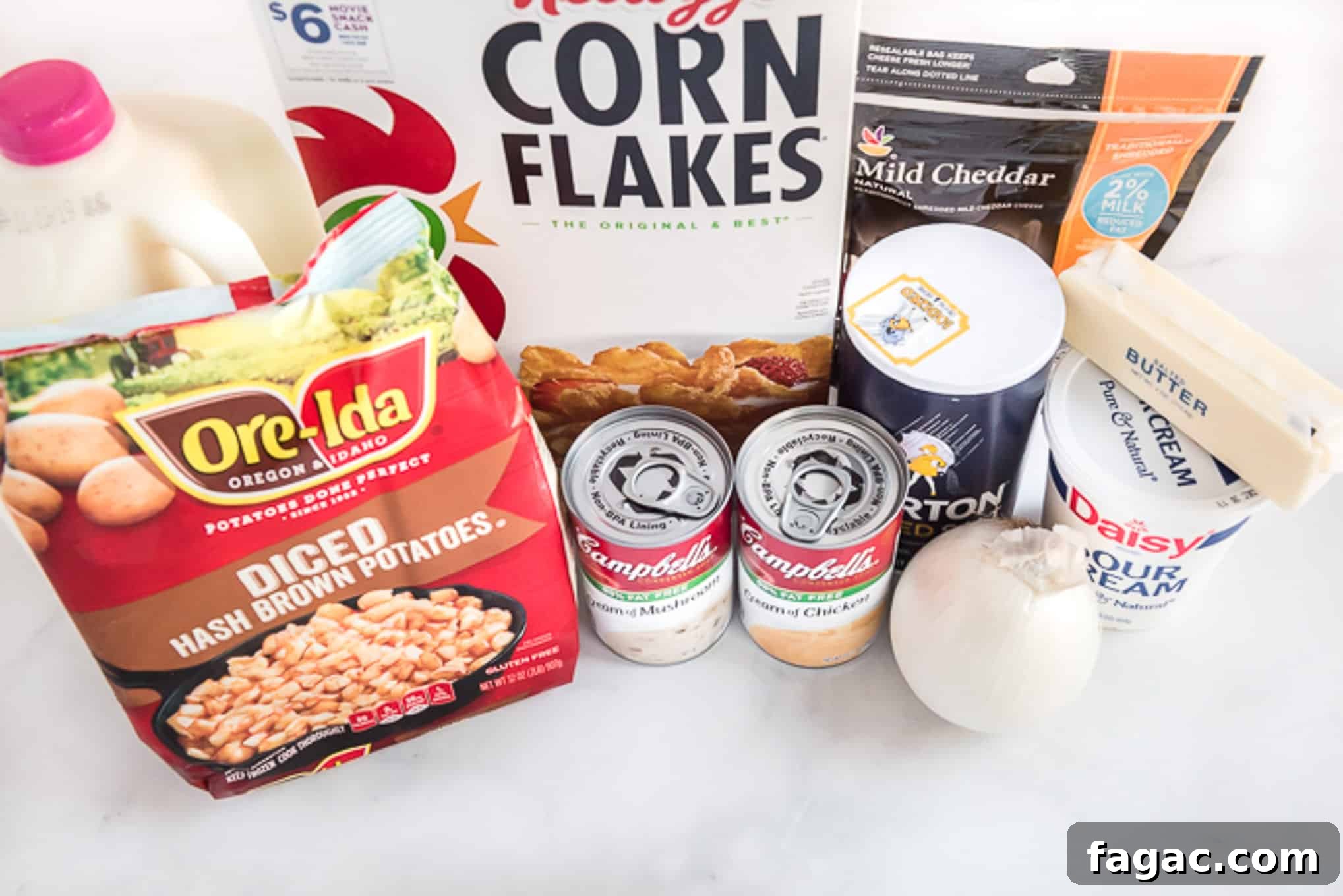 Ingredients to make cheesy potatoes with corn flakes on the counter before mixing and baking.