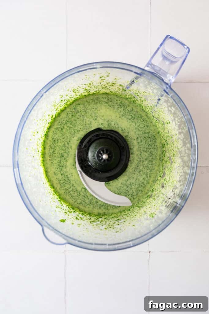 Vegan Cilantro Lime Dressing — Dairy-Free Paleo Recipe 5 A blender with a creamy green dressing in it.