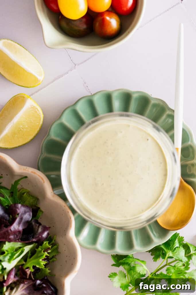 Vegan Cilantro Lime Dressing — Dairy-Free Paleo Recipe 6 A jar of creamy dressing.