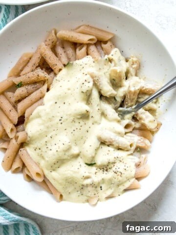 A bowl of pasta with cauliflower Alfredo sauce on it.
