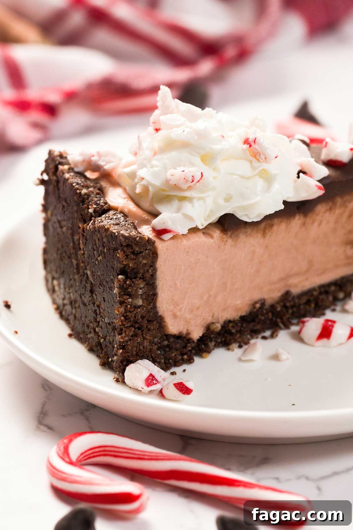 A slice of Healthier Gluten-Free Peppermint Cheesecake on a plate.
