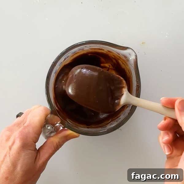 Stirring the chocolate ganache with a spatula.