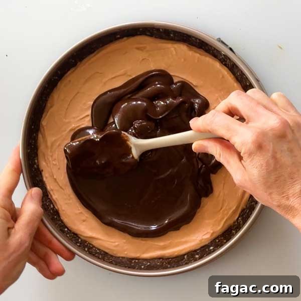 Spreading the chocolate ganache on the cheesecake.