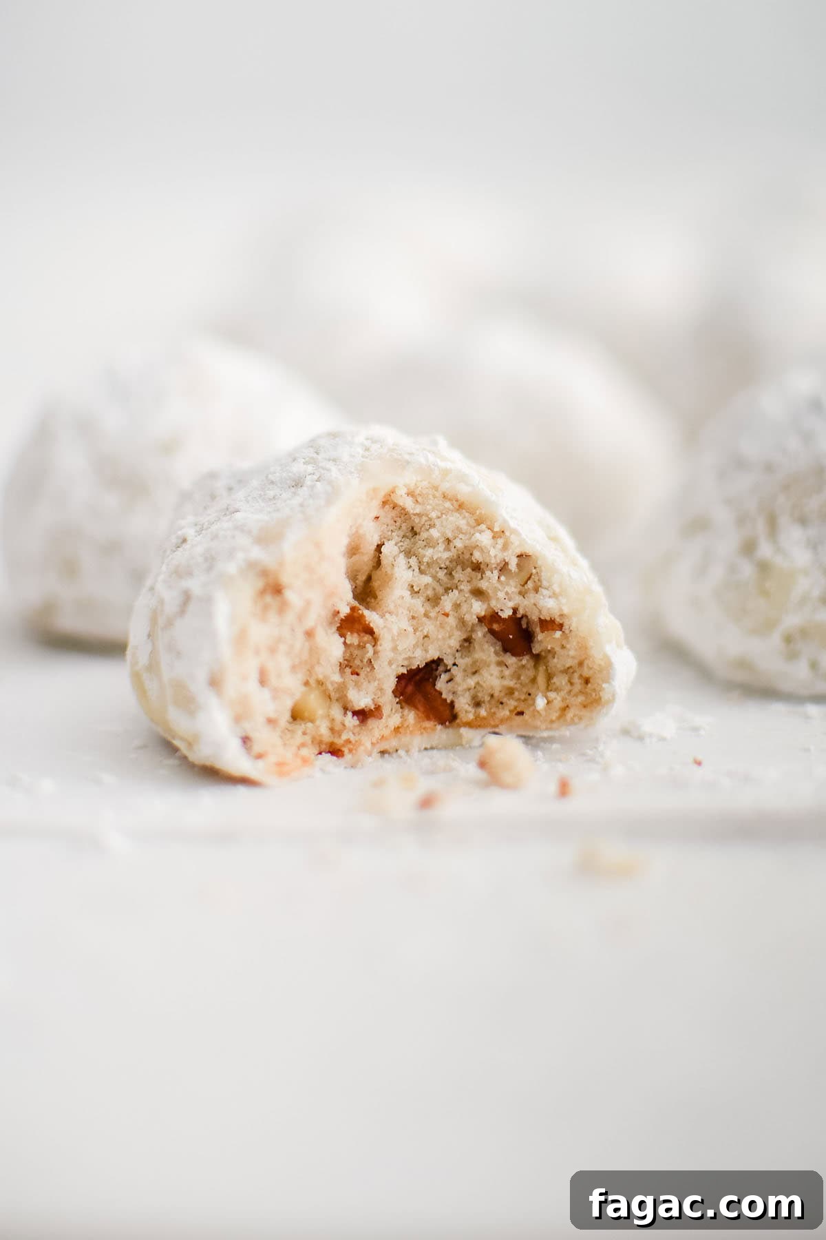 Chewy Snowball Cookies Recipe with Melt-in-Your-Mouth Filling 2 snowball cookie with a bite taken out of it