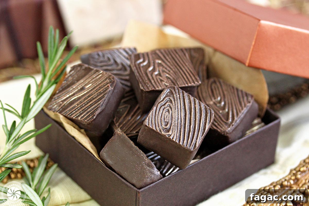 Rosemary Raspberry Truffles - close-up of square truffles with gold-flecked wood grain pattern