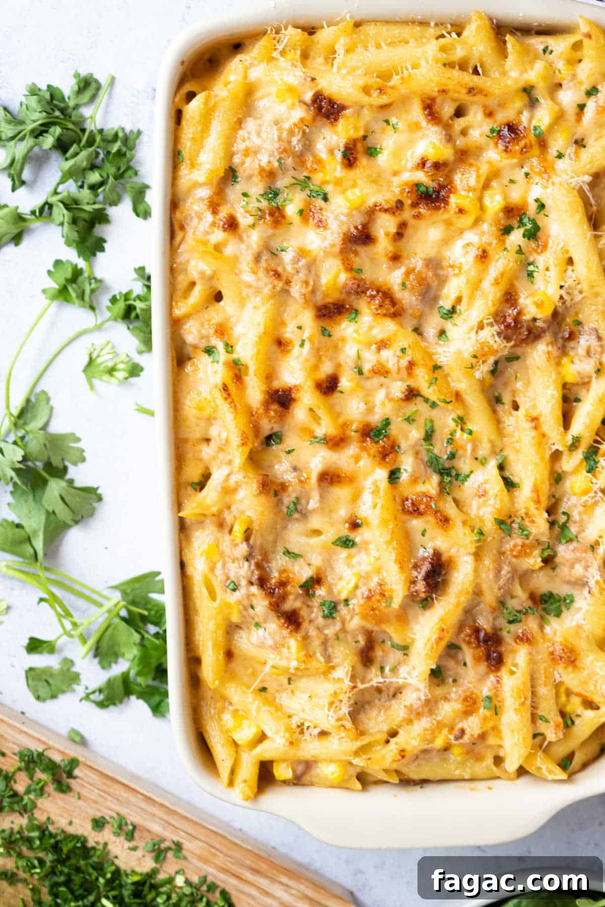 Tuna and sweetcorn pasta bake in a white baking dish.