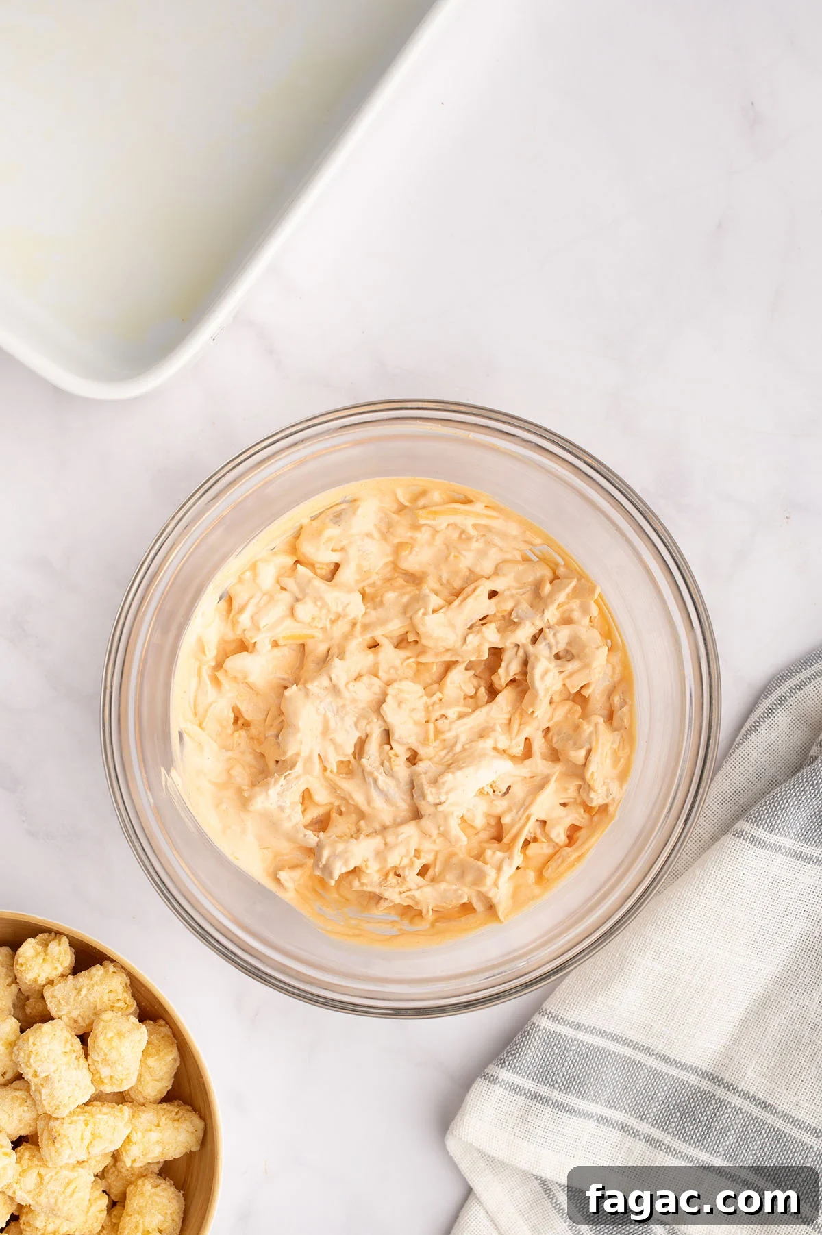 Buffalo Chicken Tater Tot Casserole Recipe with Cheesy Buffalo Sauce 5 Buffalo chicken filling in a mixing bowl.