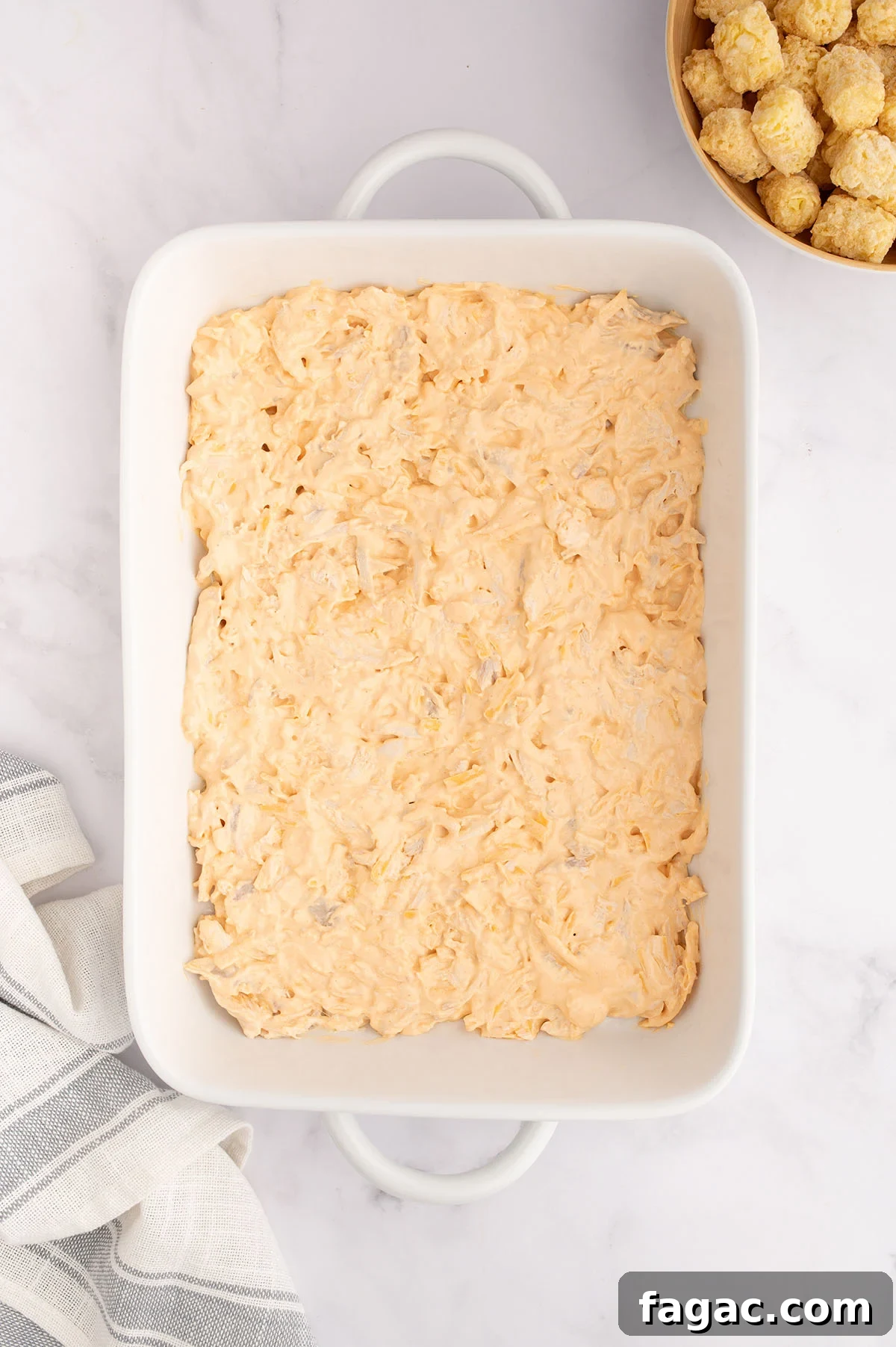 Buffalo Chicken Tater Tot Casserole Recipe with Cheesy Buffalo Sauce 6 Buffalo chicken filling was added to the baking dish.