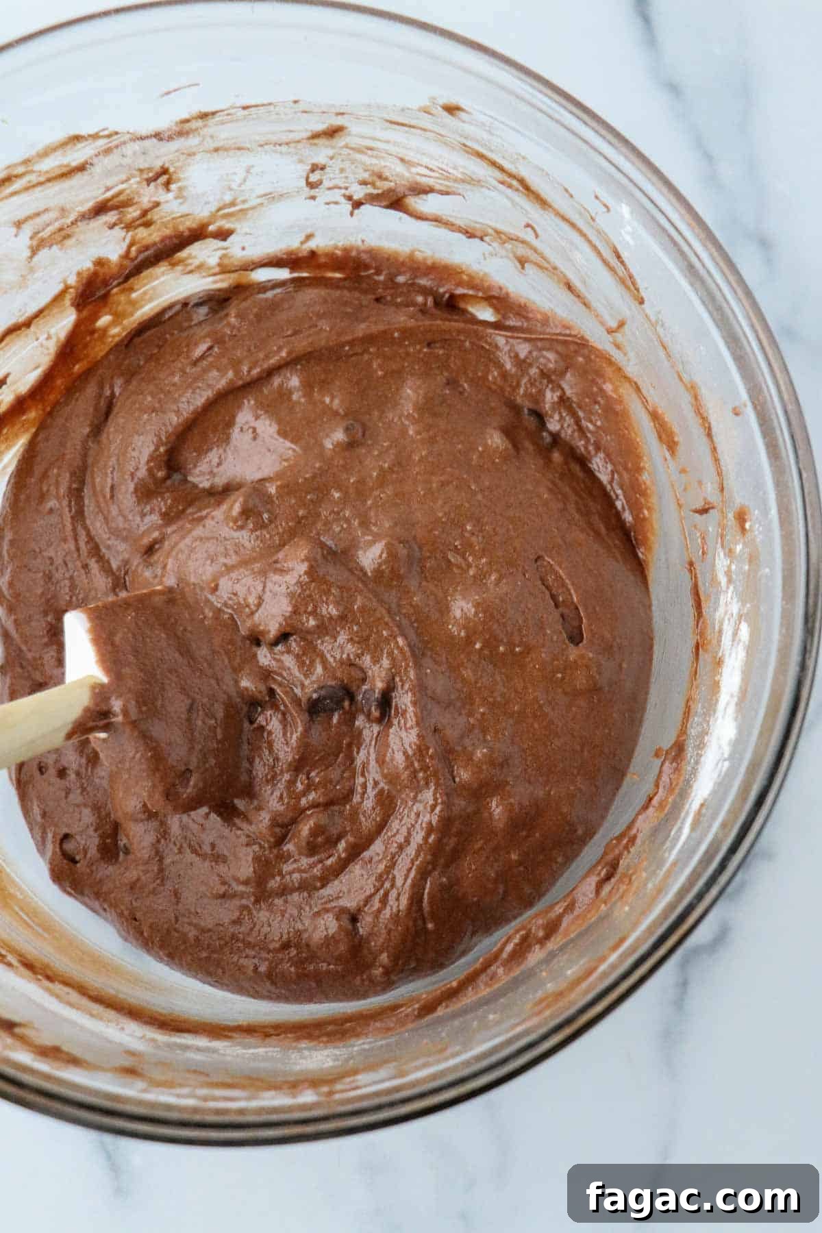 Authentic Swedish Kladdkaka: Gooey Sticky Chocolate Cake Recipe 7 Kladdkaka batter in a glass bowl with a rubber spatula.