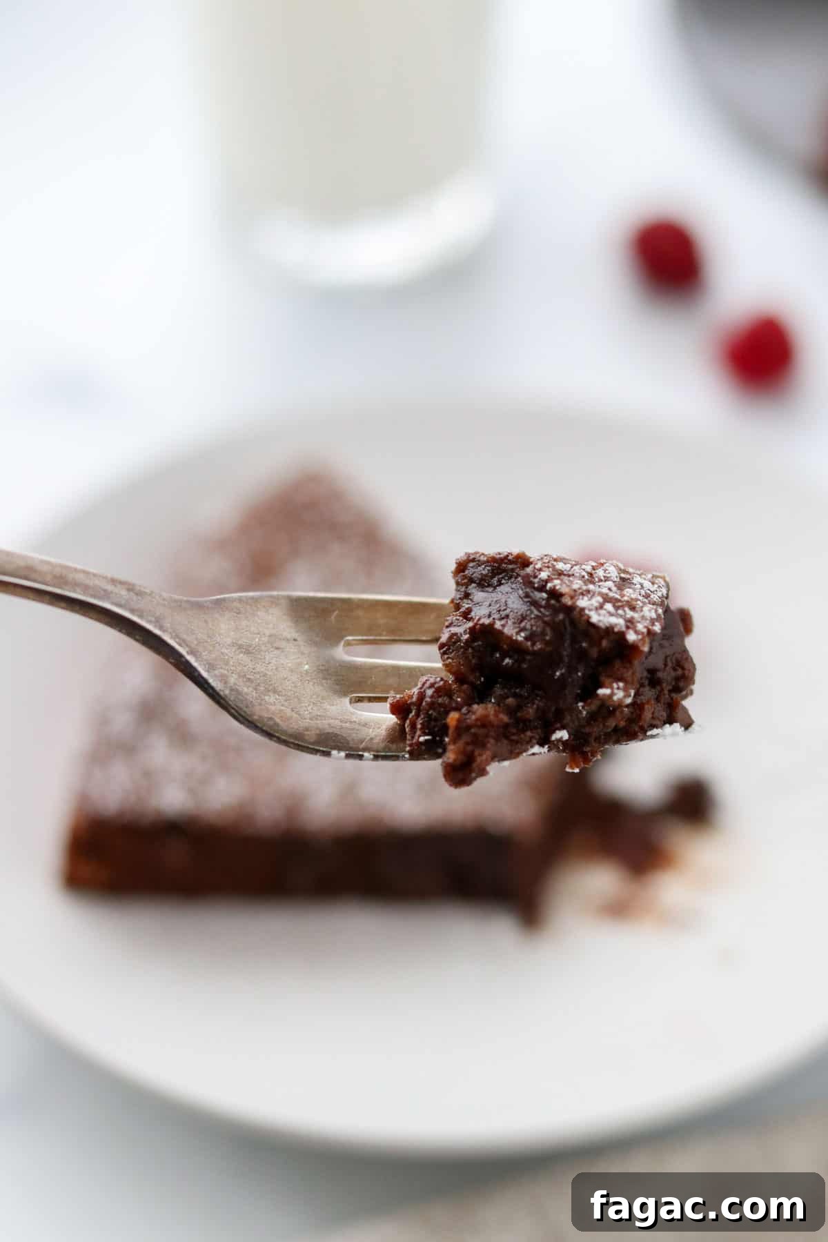 Authentic Swedish Kladdkaka: Gooey Sticky Chocolate Cake Recipe 10 Bite of Swedish Sticky Chocolate Cake (Kladdkaka) on a fork.