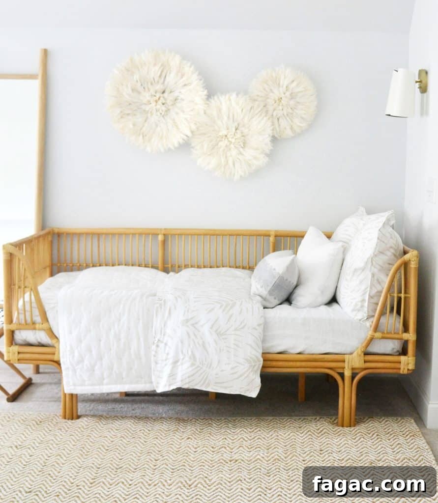 13 Stylish Rattan Daybeds and How to Style Them 4 my rattan daybed with blankets and pillows on top, and juju hats above it on the wall