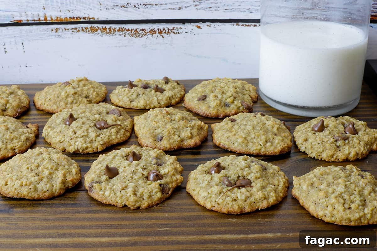 Chocolate Chip Banana Oat Oatmeal Cookies Recipe 10 baked cookies on wooden board with glass of milk in background