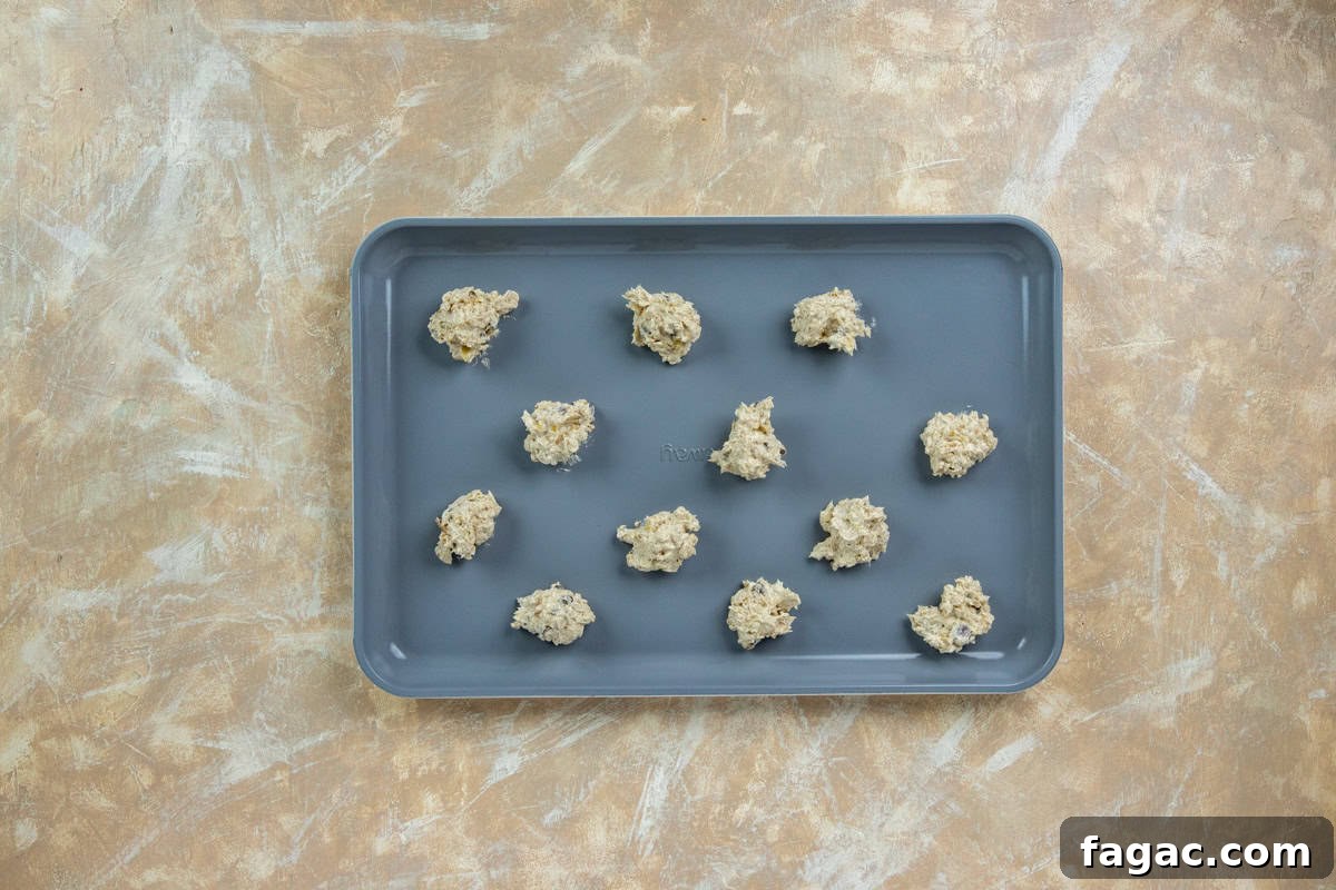 Chocolate Chip Banana Oat Oatmeal Cookies Recipe 6 Twelve raw cookie dough spoonfuls on a baking sheet.
