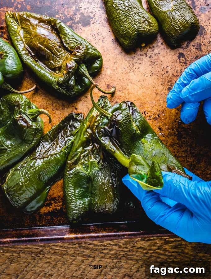 Roasted poblano peppers being peeled.