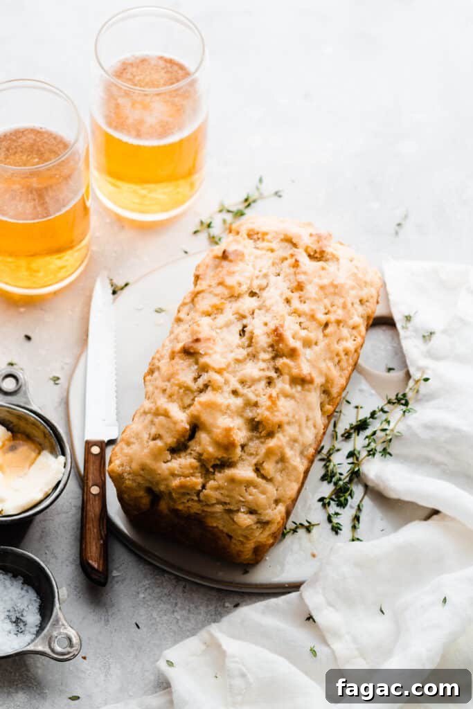 Classic Beer Bread with Salted Honey Butter Recipe 8 A loaf of beer bread on a serving plate