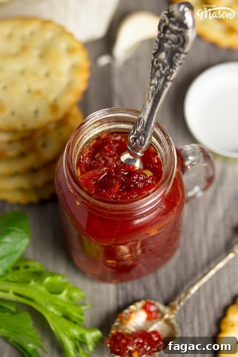 Homemade Sweet Chili Jam Recipe for Bold Flavor 2 sweet chilli jam in a kilner jar with crackers, lettuce and garlic cloves