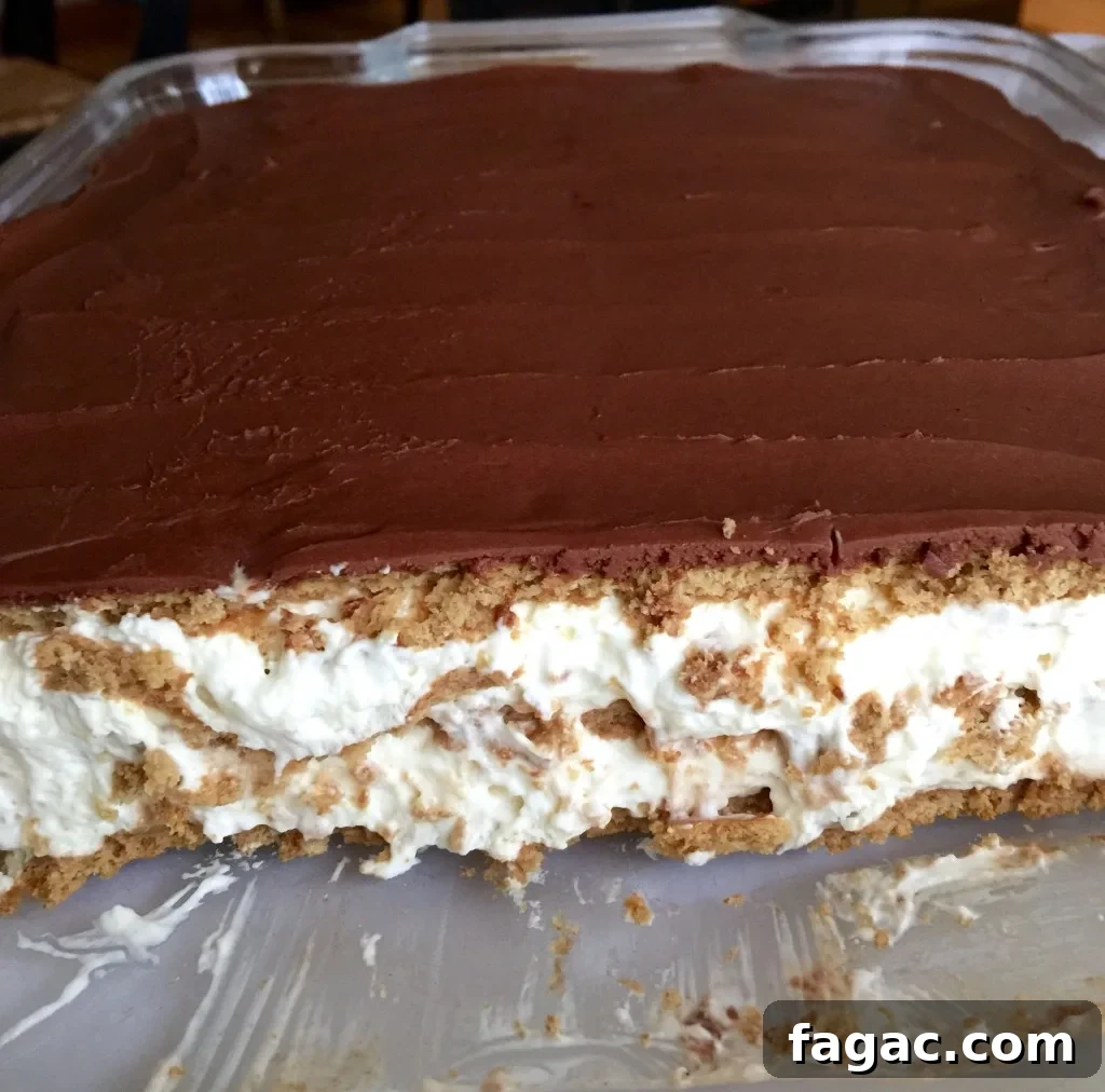 Éclair Cake, in pan, cut to show layers.