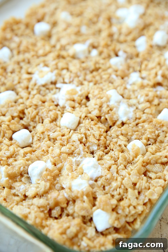 Peanut Butter Rice Krispie Treats Recipe: Chewy No-Bake Squares 6 A diagonally placed 9x13 glass baking dish of peanut butter Rice Krispie treats.