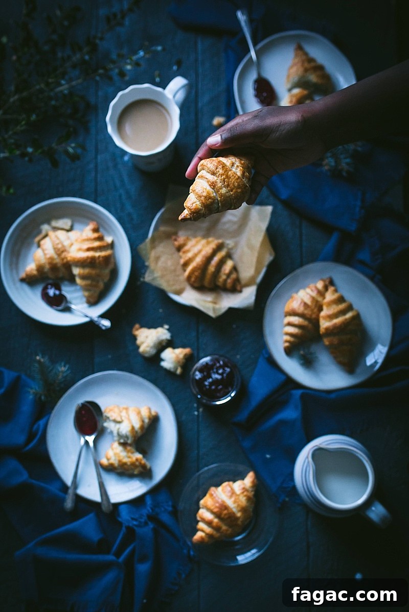 boy holds a croissant
