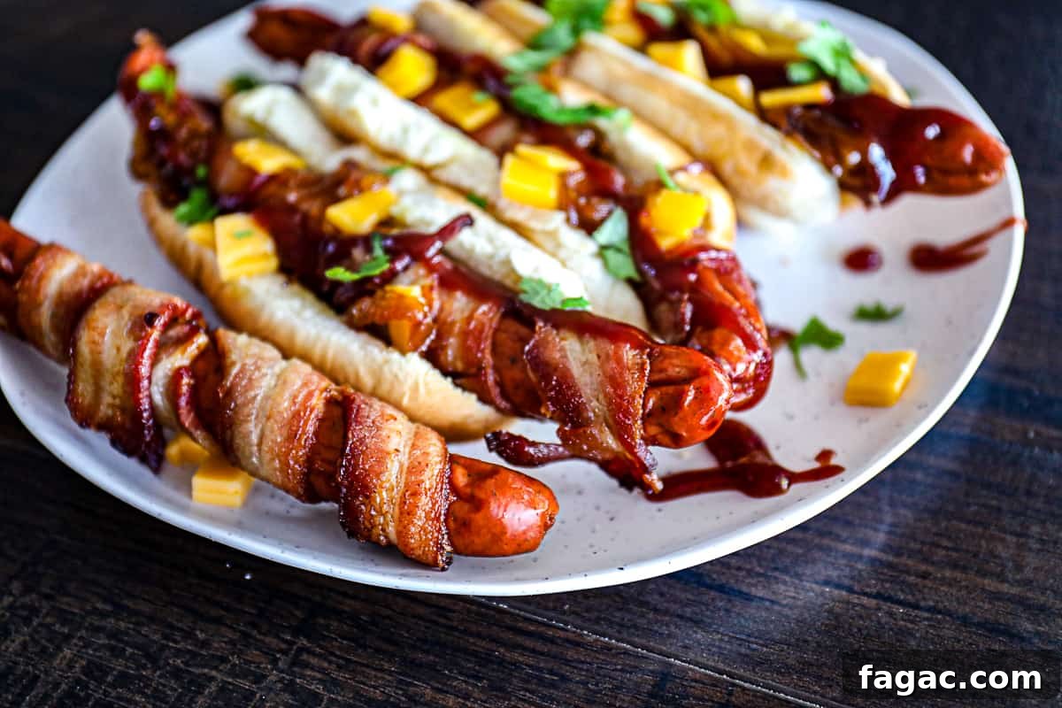Crispy Bacon-Wrapped Hot Dogs: Air Fryer, Oven & Grill Methods 7 Cooked Bacon Wrapped Hot Dogs with cheddar cheese and bbq sauce.