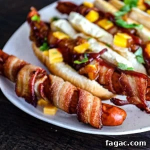 Crispy Bacon-Wrapped Hot Dogs: Air Fryer, Oven & Grill Methods 9 Closeup shot of Bacon Wrapped Hot Dogs.